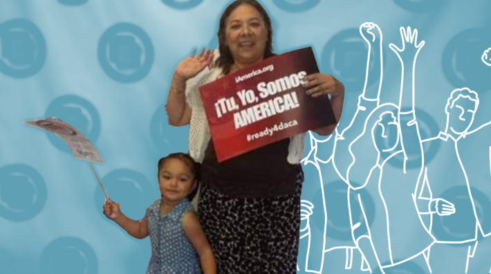 Maria, SEIU worker, holding a sign that says "Tu Yo Somos America"