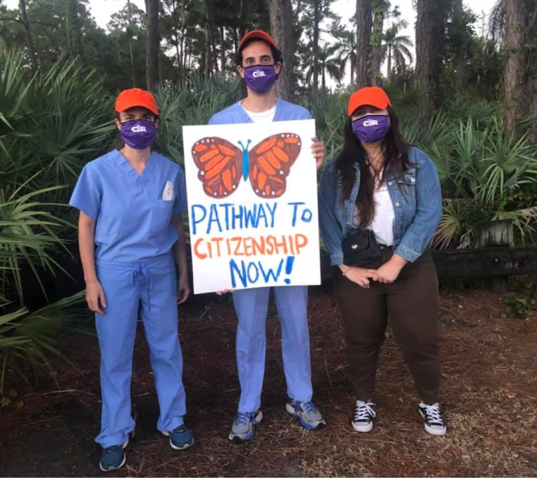 CIR members posed for a photo, holding a sign with a butterfly that reads "pathway to citizenship now!"