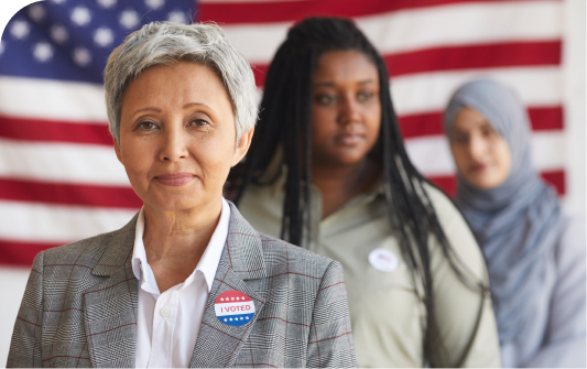 Multi-ethnic group of women wearing I Voted stickers